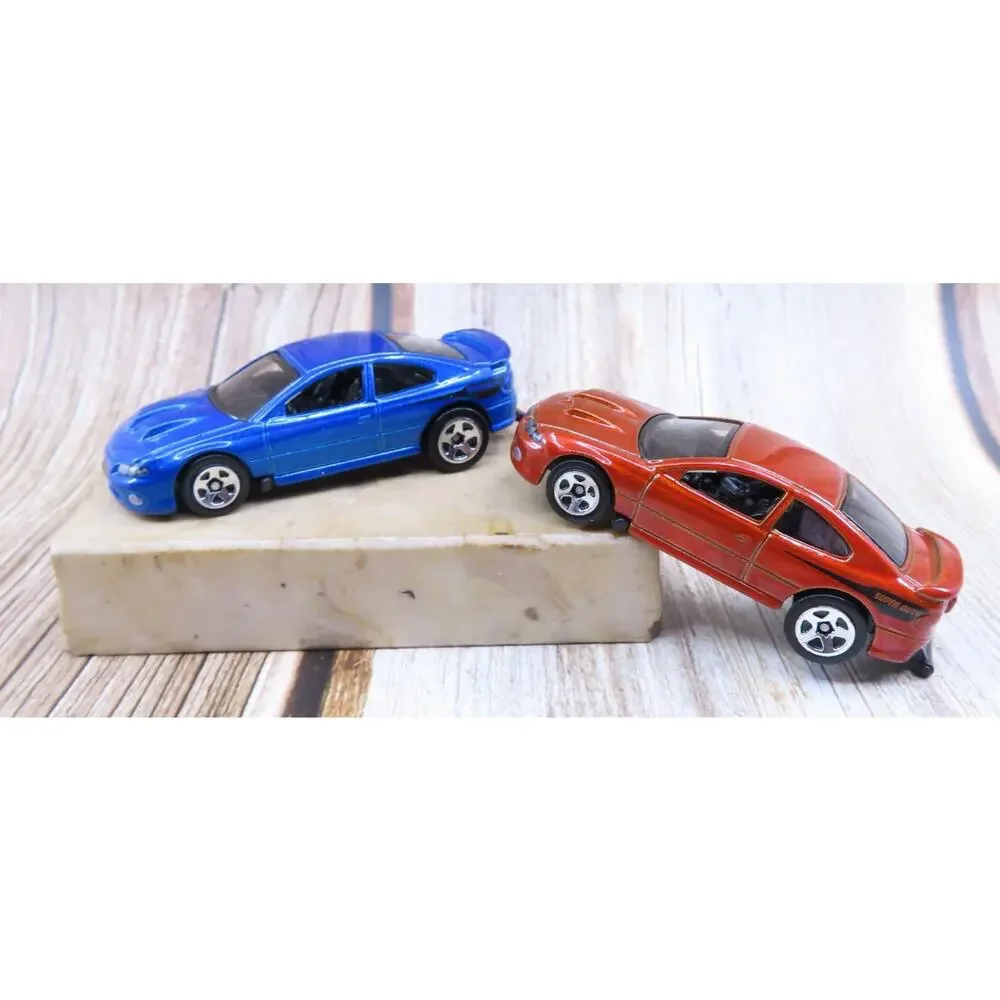 Hot Wheels PONTIAC '06 GTO LOT of 2 Factory Fresh Orange and Blue 1:64 Loose